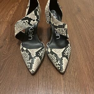 Calvin Klein “Gella” pointed toe heels in a Black/Cream Snakeskin print/leather